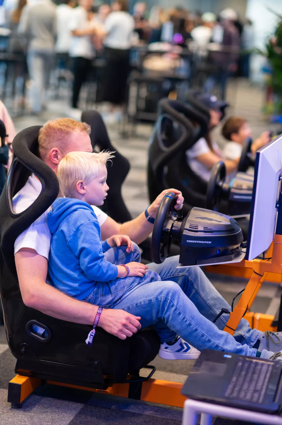 A father and son playing a car simulation game